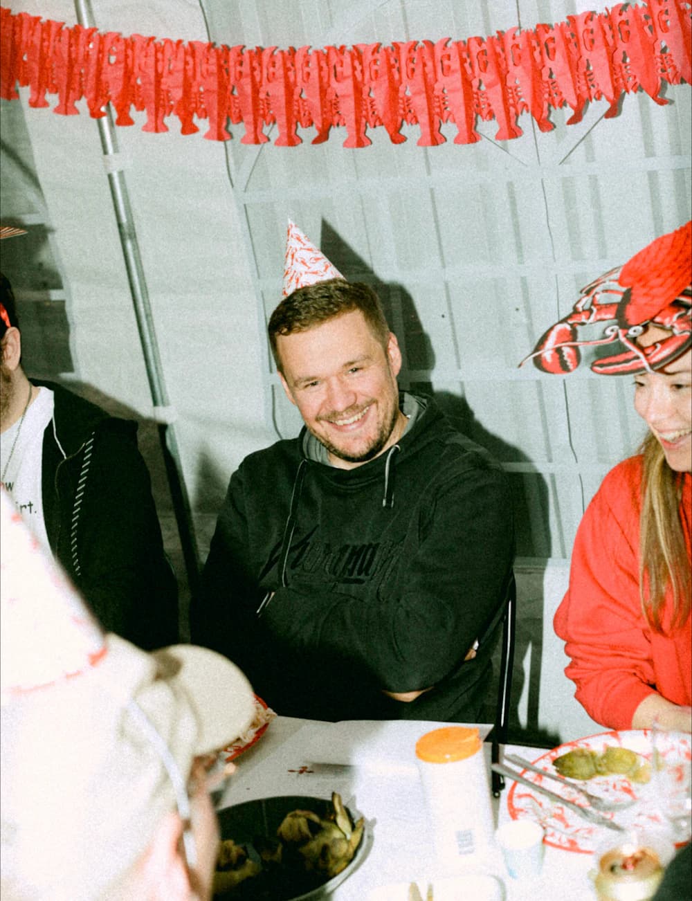 A colleague in a party hat at the crayfish party
